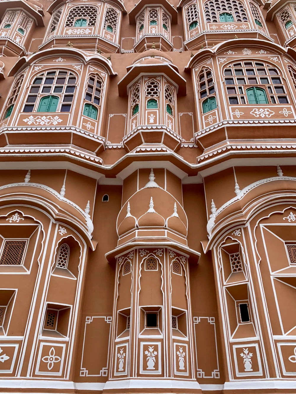 The pink sandstone facade of Hawa Mahal in Jaipur